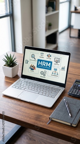 Business professional analyzing HR management data on laptop. Modern office workspace with digital human resources tools.