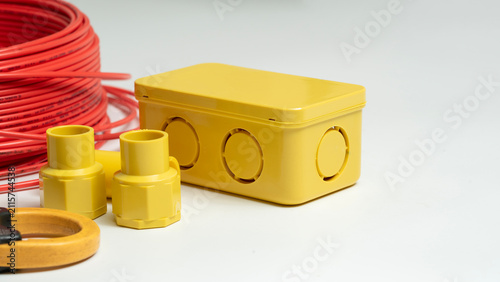 Foto Close-up electrical junction box and red roll electrical wire isolated on white background