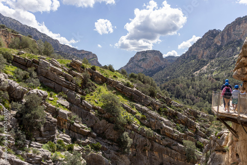 Tourists walking along suspended wooden platform Caminito del Rey over Guadalhorce river, Spain, Andalusia, El Chorro
