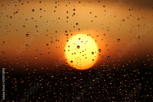 Raindrops on Window Glass During Golden Hour Sunset