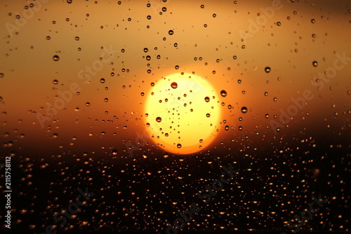 Raindrops on Window Glass During Golden Hour Sunset