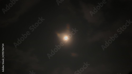 Full moon time lapse, moonlight illuminating moving clouds at night, Bali, Indonesia