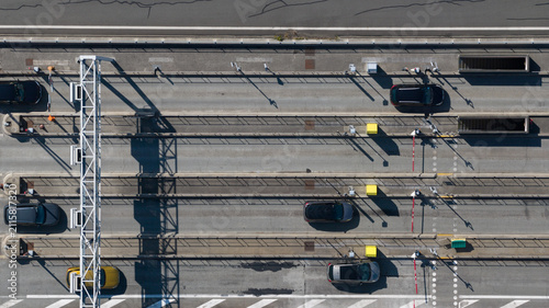 Aerial view of the Gare de Peage de Dury toll station with cars passing through lanes, overhead gantries, and road markings in Saleux, Hauts-de-France, France.