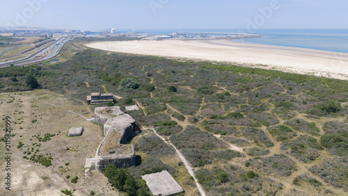 Aerial view of Battery Oldenburg, a historic World War II bunker complex surrounded by coastal dunes and vegetation near the beach in Calais, Hauts-de-France, France.