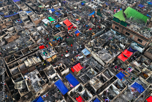 Aerial view of the aftermath of a fire at Korail Basti, showing destroyed structures, debris, and makeshift shelters in Dhaka, Dhaka Division, Bangladesh.