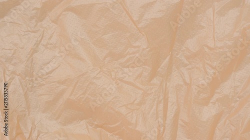 Crumpled Peach Tissue Paper Shifts Across a Minimal Clean Surface, Creating a Seamless Abstract Background for Typography, Presentations, Overlays and Motion Graphics