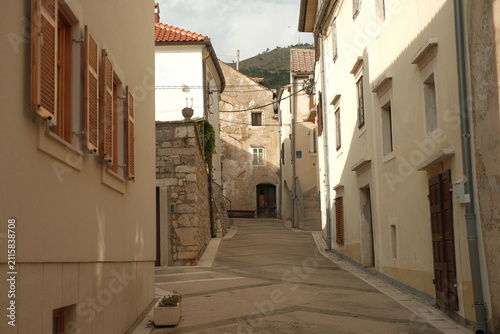 Traditional stone houses and cobbled alleyway in Senj city center