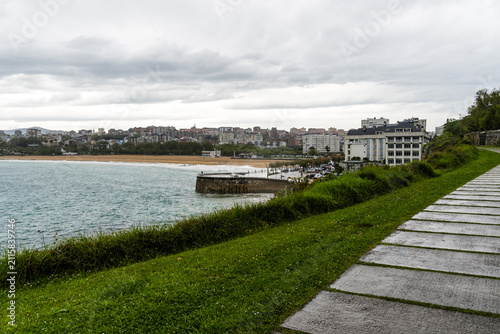 Scenic view of Sardinero Beach promenade in Santander, Spain, on a cloudy day.