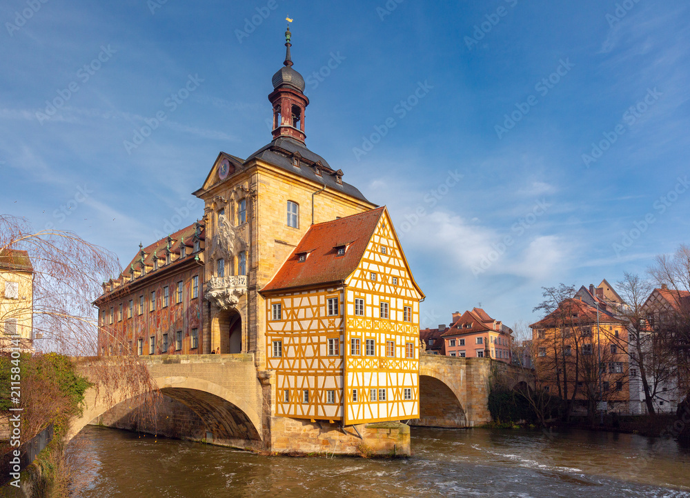 Fototapeta premium View of the historic City Hall, traditional buildings and the Regnitz River in the center of Bamberg, Bavaria, Germany.