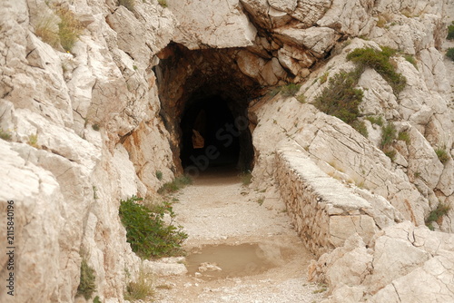 Scenic rock tunnel and cave along the Zavratnica bay hiking trail