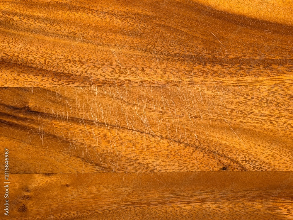 Fototapeta premium Scratched wooden surface texture background with warm natural grain