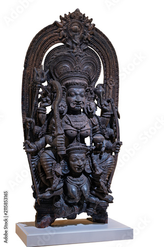 Detailed carved wooden statue of Hindu deity Chamunda with multiple arms and traditional iconography isolated on a white background.
