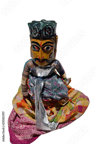 Traditional Kathputli Indian string puppet dressed in colorful fabric isolated on a white background.