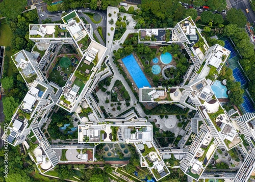 Aerial view of The Interlace residential complex featuring interlocking apartment blocks, lush green roof gardens, swimming pools, and tennis courts in Singapore, Singapore.