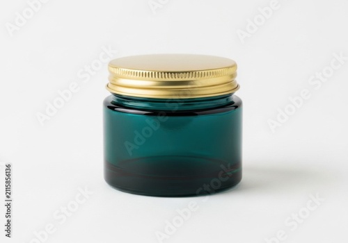 Emerald green glass cosmetic jar with gold metallic lid