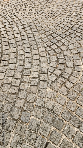 Obraz na plátne Neatly and symmetrically arranged concrete pavers set amidst a spacious park, ba