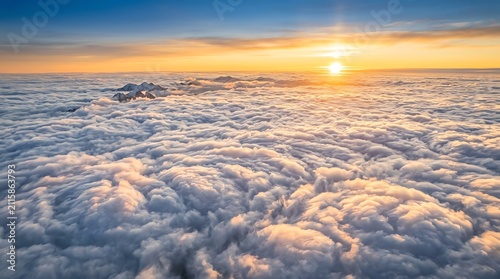 Sunset Over Cloudscape with Mountain Peaks and Golden Sky