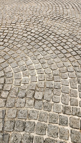 Neatly and symmetrically arranged concrete pavers set amidst a spacious park, bathed in invigorating sunlight—an ideal spot for family recreation and exercise, fostering family bonding and outdoor act