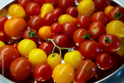 View of different types of cherry tomatoes on a silver tray
