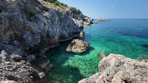 Sveti Ivan Beach on Croatia's Cres Island reveals shimmering blue-green Adriatic waters, vibrant Mediterranean hillsides, and several anchored boats floating peacefully near untouched rocky shoreline.
