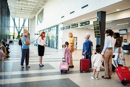 Bild auf Leinwand Passengers with children waiting in airport terminal for check-in