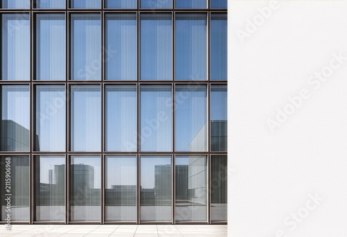 Modern office building glass facade with blank white concrete wall. Contemporary corporate architecture exterior with empty copy space for logo mockup, billboard or business presentation.
