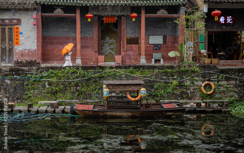 Cuadro en lienzo Traditional wooden boat docked along a narrow canal beside historic Lingnan-style architecture in Nanshe Ancient Village, Dongguan, Guangdong, China