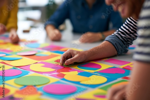 Team Building Creativity with Colorful Paper Shapes on Table