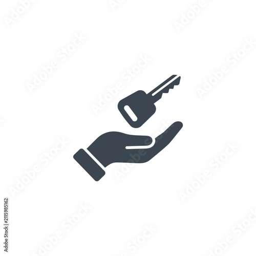 Hand holding a metal house key.