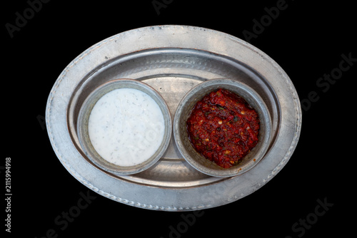 Obraz na plátne Serving of yogurt and spicy sauce in bowls on a silver platter