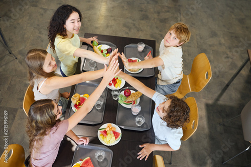 Group of children enjoying lunch together in a school cafeteria