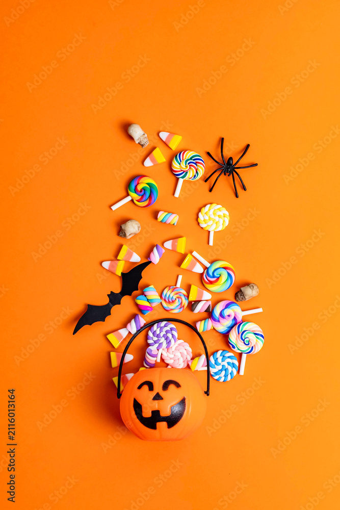 Fototapeta premium Halloween trick or treating candy overflowing pumpkin basket