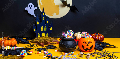 Halloween celebration with candy, pumpkins, and haunted castle decorations