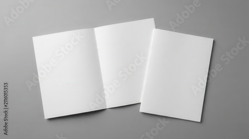 Top view of open and closed blank brochures on a grey background for design mock up