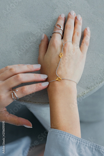 female hands with the hand chain and ring jewelry bijouterie 
