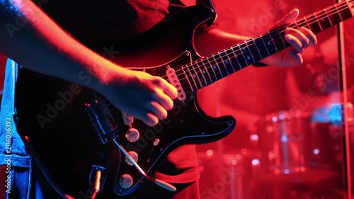 Close-up of musician playing electric guitar at live concert