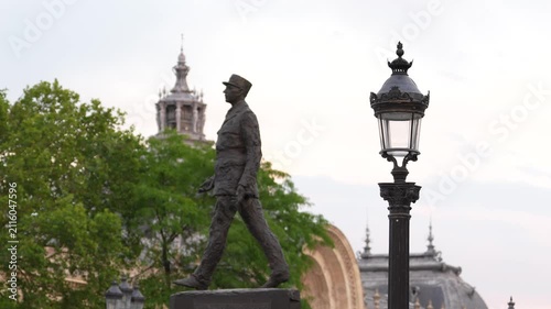 Cinematic footage of the iconic Pont Alexandre III bridge in Paris, France. The video showcases the bridge's elegant Beaux-Arts architecture, ornate golden sculptures, decorative lamp posts.