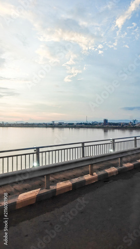 Serene Riverbank Scenic View at Dusk with Calm Water Reflections
