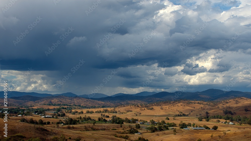 Fototapeta premium Beautiful and breathtaking view of rain over distant hills. Landscape of rainy hamra over hills.
