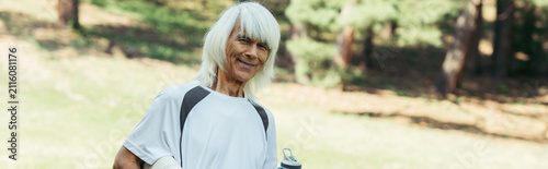 Принти на полотні Senior man embracing vitality while working out in a vibrant green park