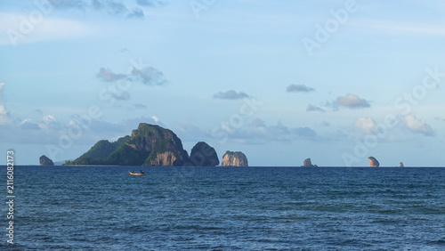 Experience the breathtaking beauty of the tropical beach at Ao Nang, Krabi Province, Thailand. Waves lap against the sandy shore, where turquoise waters and the Andaman Sea’s 