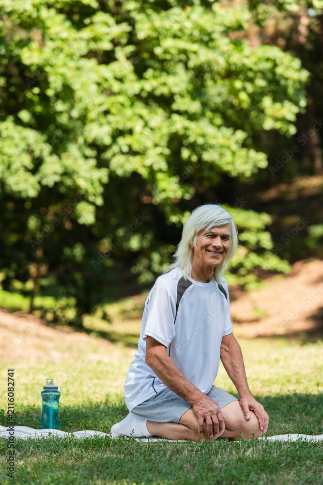 Fototapeta premium Senior man enjoying outdoor workout in green park, embracing a healthy lifestyle