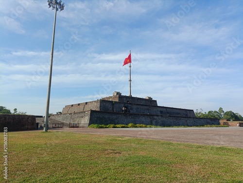 Photography Historic flag tower of the Imperial Citadel with Vietnamese flag in Hue, Vietnam