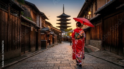 Japanese Woman in Red Kimono Walking in Historic Kyoto Street at Sunset with Yasaka Pagoda