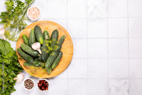 Fresh cucumbers and pickling ingredients on white background