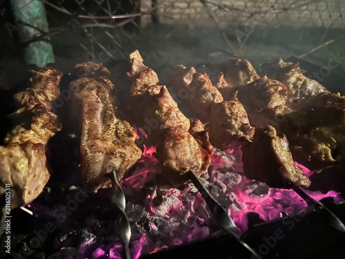 Pork grilled over coals in the evening heat