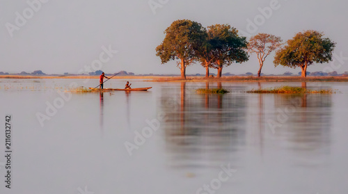Serene view of two fisherman in a mokoro on the Chobe river