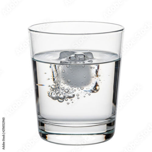 A clear glass filled with water and a floating ice cube.