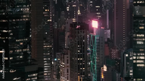 July 24 2026 Illuminated office skyscraper glowing in Causeway Bay night.