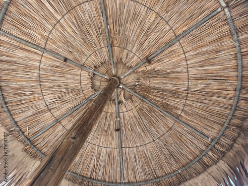 Symmetric Underneath Perspective of Reed Beach Parasol Frame and Wooden Pole